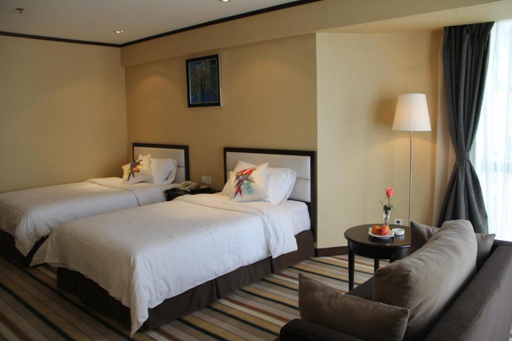 Postel nebo postele na pokoji v ubytování Shenzhen Shekou Honlux Apartment (Sea World)