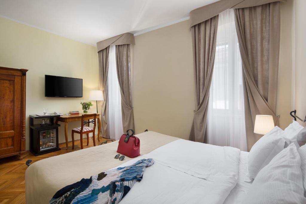 Łóżko lub łóżka w pokoju w obiekcie Hotel Angelo d'Oro