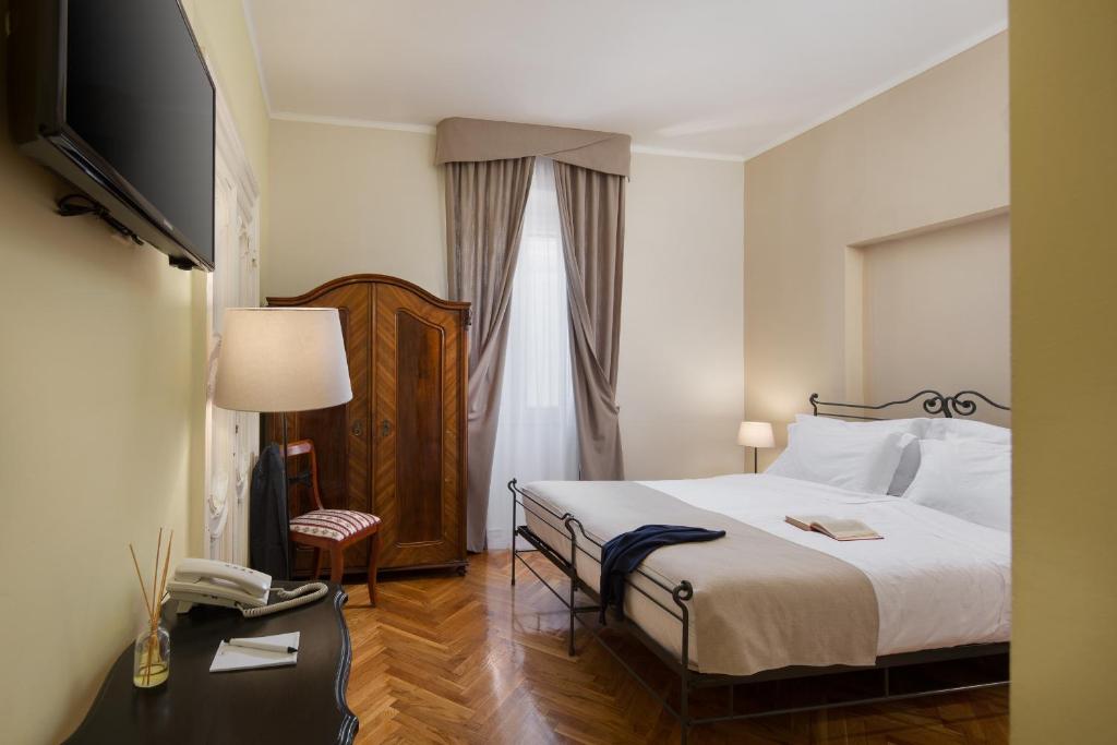 Łóżko lub łóżka w pokoju w obiekcie Hotel Angelo d'Oro