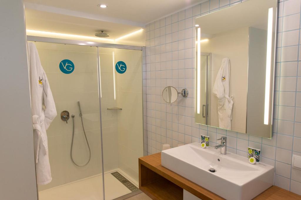 a bathroom with a sink and a shower at Vanilla Garden Boutique Hotel - Adults Only in Playa de las Americas