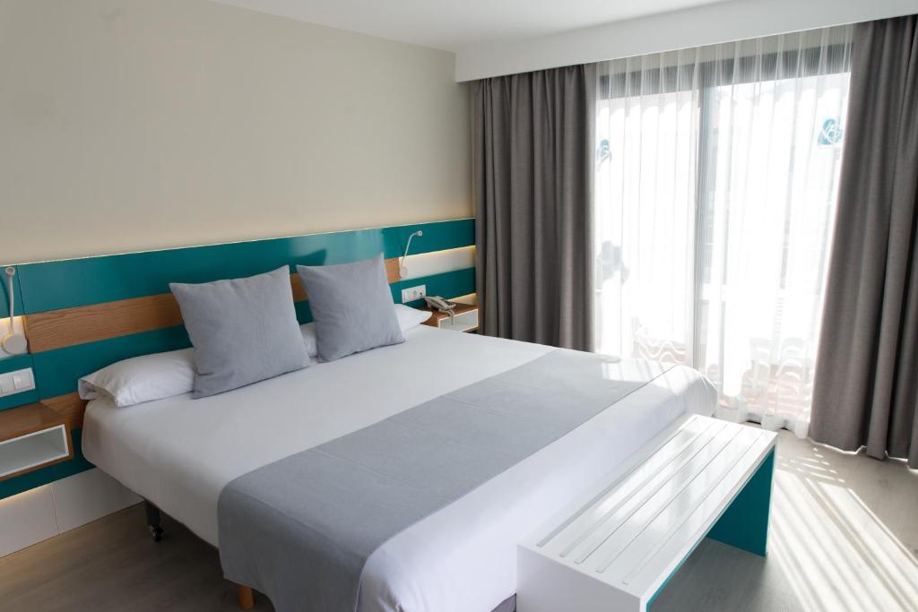 a large white bed in a room with a window at Vanilla Garden Boutique Hotel - Adults Only in Playa de las Americas