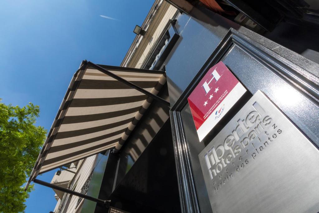 a sign on the side of a building with a flag at Libertel Austerlitz Jardin des Plantes in Paris