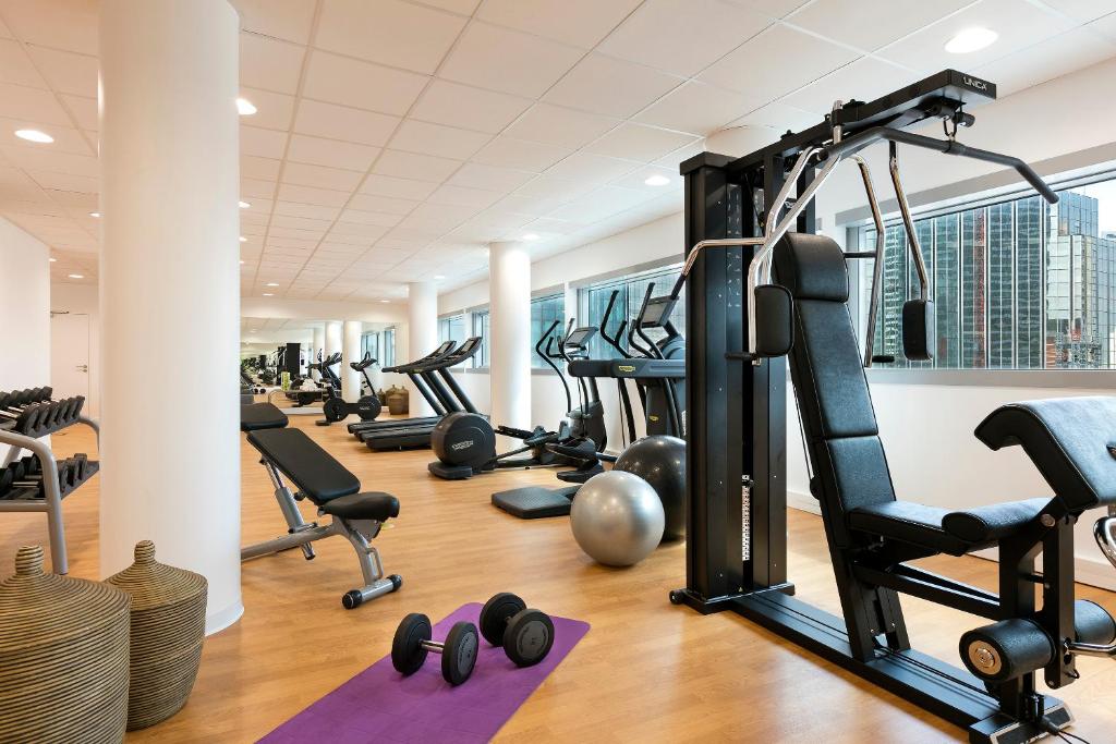 a gym with a row of tread machines and pilates equipment at Melia Paris La Defense in Courbevoie