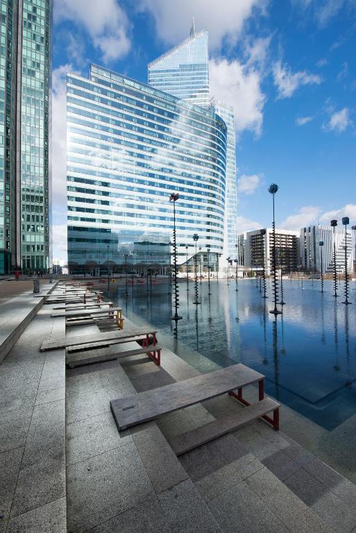 a row of benches in front of a large building at Melia Paris La Defense in Courbevoie