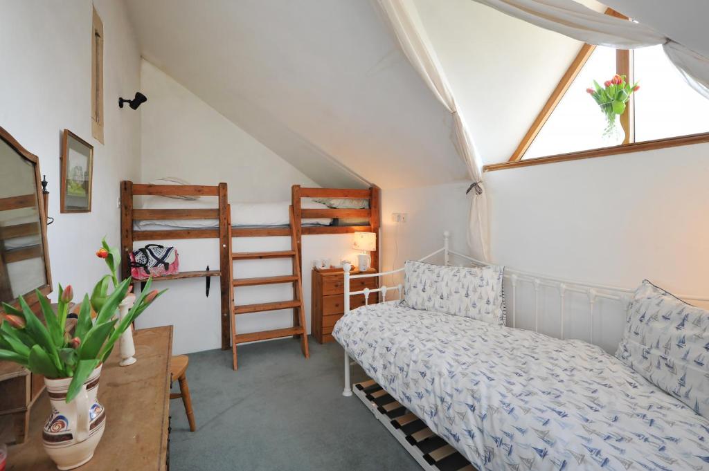 a room with a bed and two bunk beds at Thistle Barn in Bath