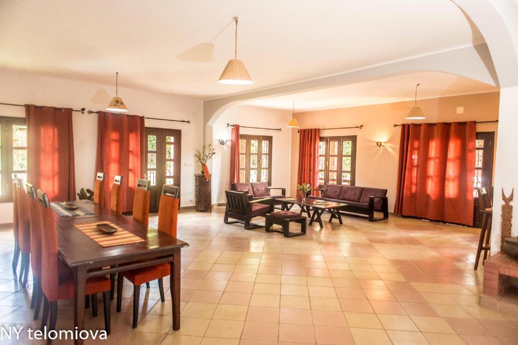 a large living room with a table and chairs at NY Telomiova in Antananarivo