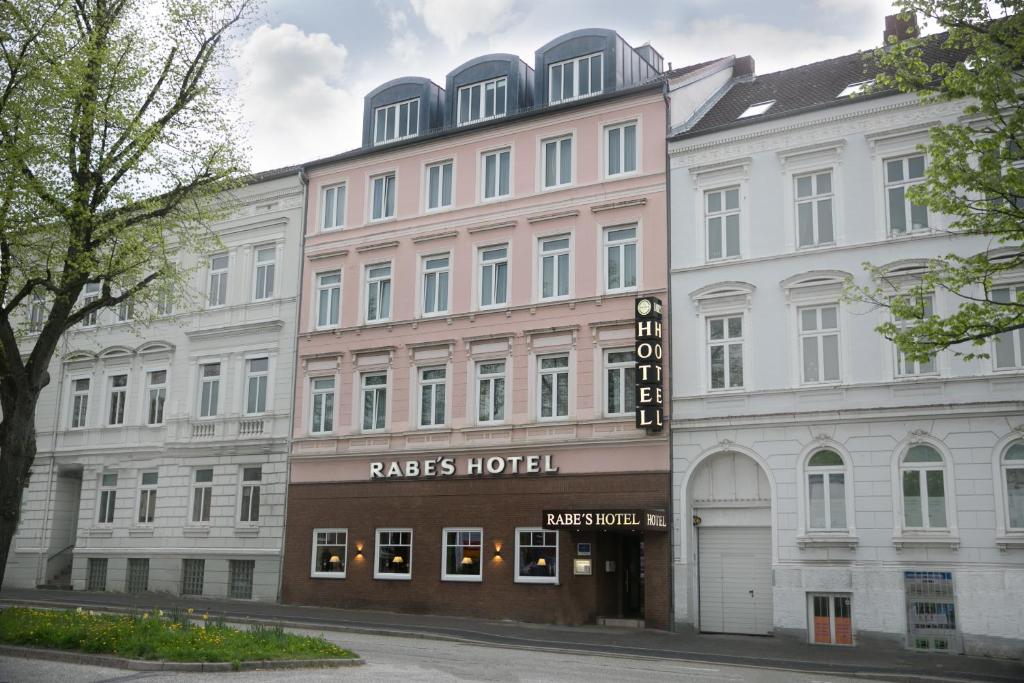 a large building with a hotel on a street at Rabes Hotel Kiel in Kiel
