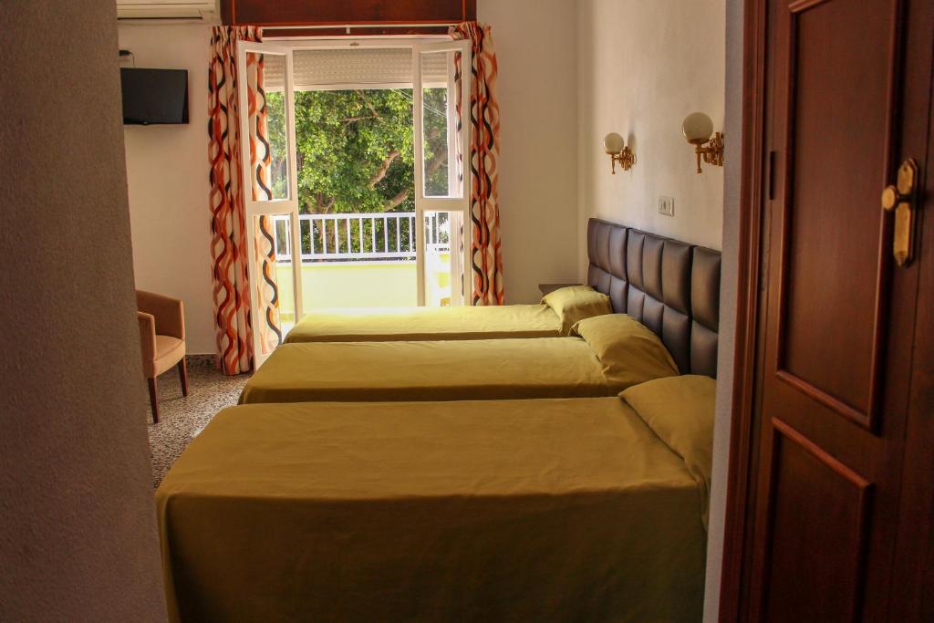 Postel nebo postele na pokoji v ubytování Hostal Esperanza