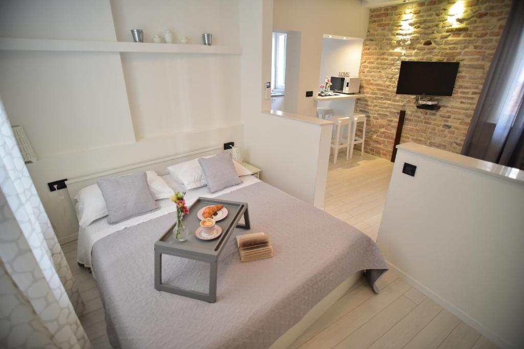 a small living room with a bed and a table at Zadar Sweet Studios in Zadar
