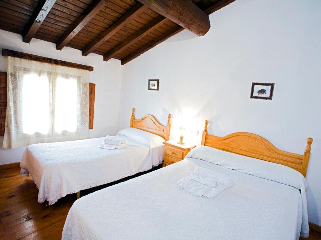 Casa rural El Corralón tesisinde bir odada yatak veya yataklar