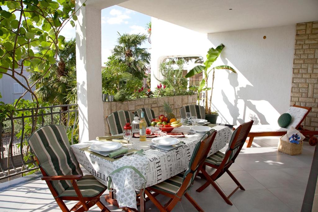 einen Tisch und Stühle auf einem Balkon mit Tisch und Zehen in der Unterkunft Melanija 1 in Rovinj