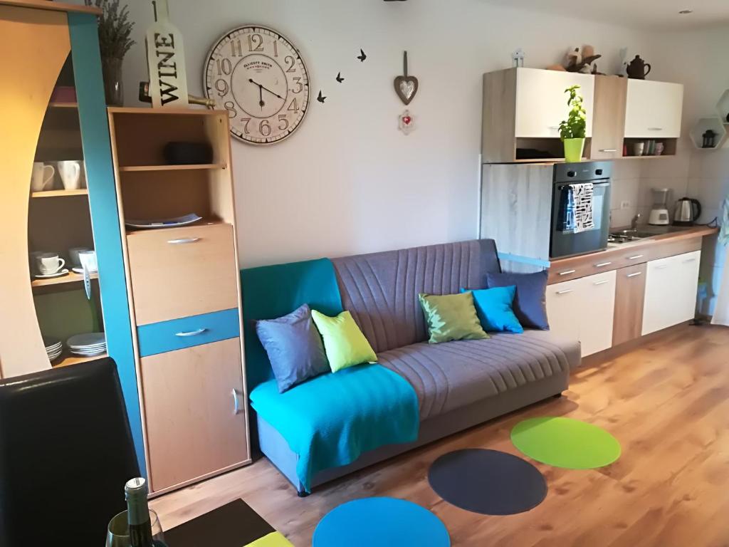 a living room with a blue couch and a kitchen at Apartment Ane in Bale