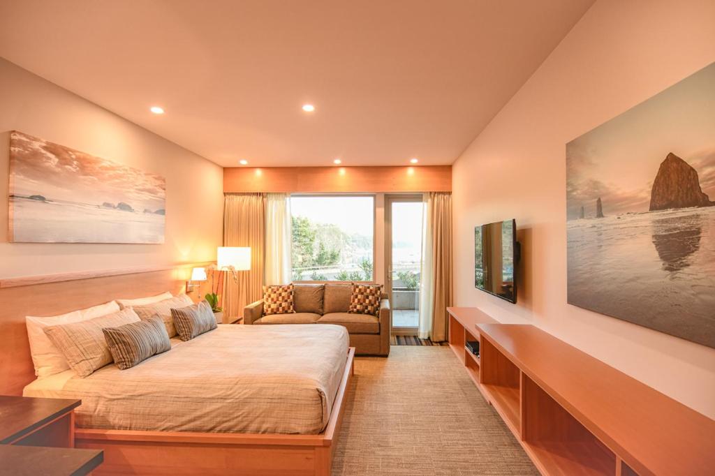 a bedroom with a bed and a couch and a tv at Harbour House Hotel in Ganges