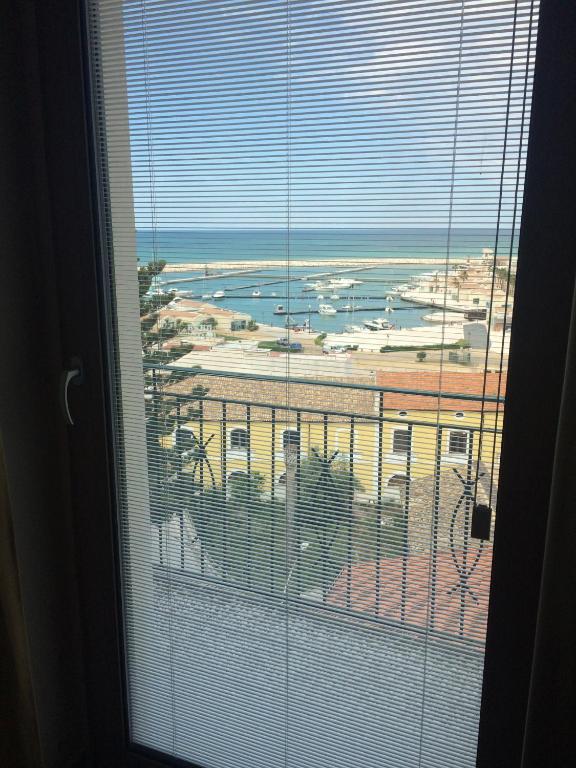 a window with a view of a city and the ocean at Residence Ducale in Rodi Garganico