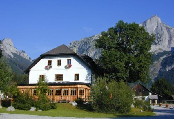 a large white house in front of a mountain at Der Bodenbauer in Thörl