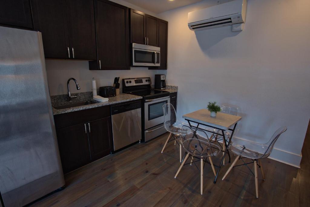 a small kitchen with a table and chairs in it at 493 King Two Bedroom Suites in Charleston