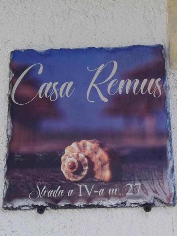 a sign that says casa remalis with a snail on it at Casa Remus in Sulina
