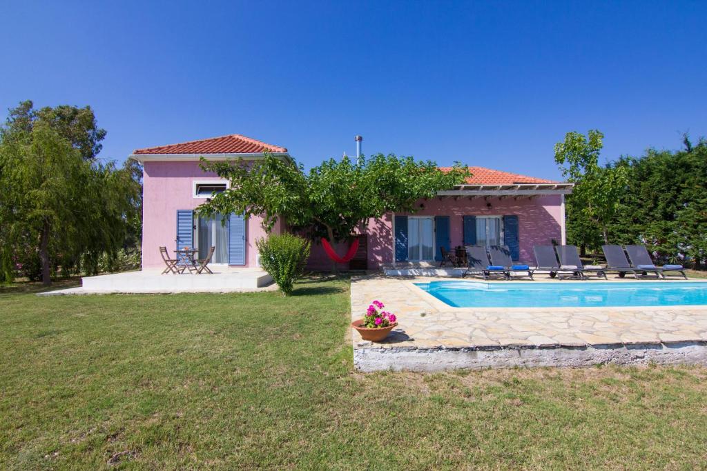 a house with a swimming pool in a yard at Kefalonia Ammos Villa in Lixouri