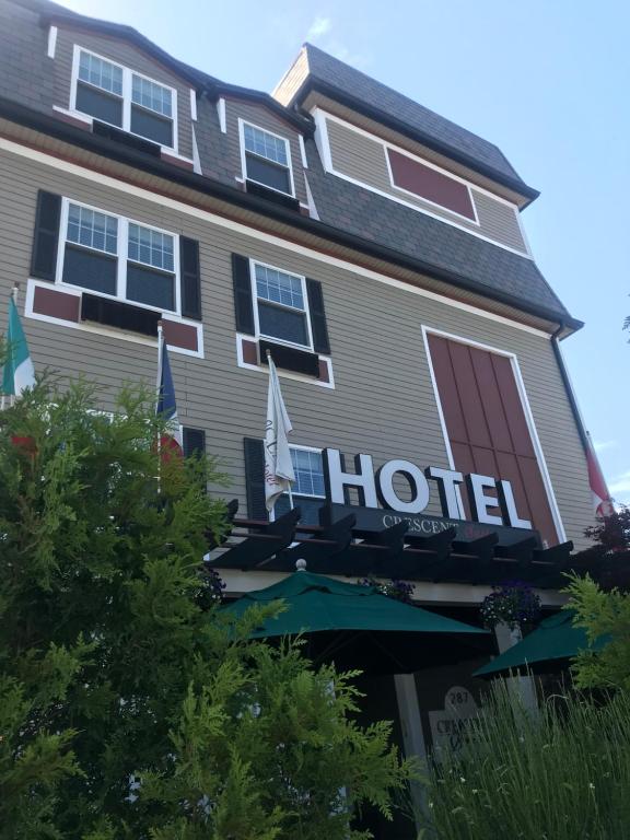 a hotel with a sign on the side of it at Crescent Suites Hotel in Waltham
