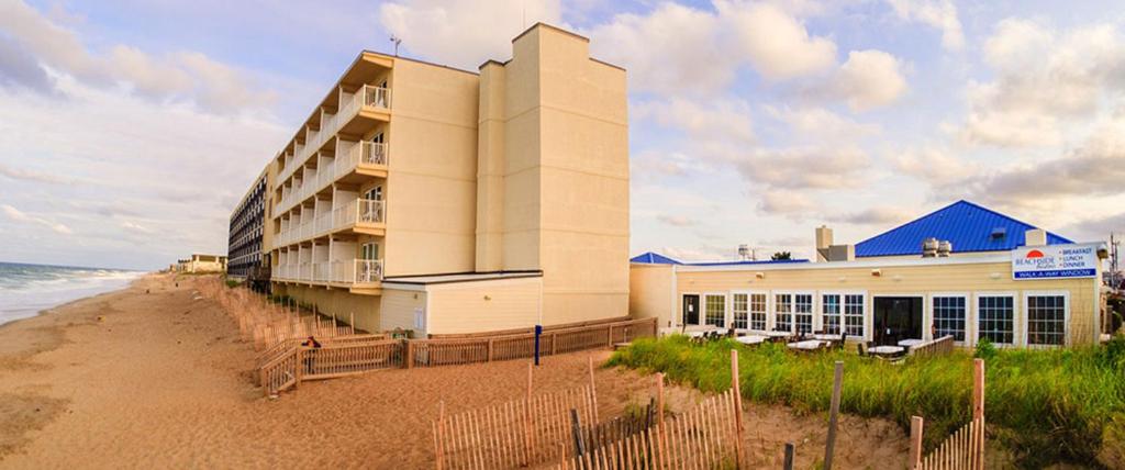 a building on the beach next to the ocean at The Sea Ranch Resort in Kill Devil Hills