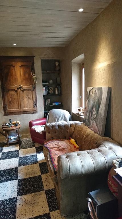 a living room with a couch and a checkered floor at La belle endormie in Cabrerolles