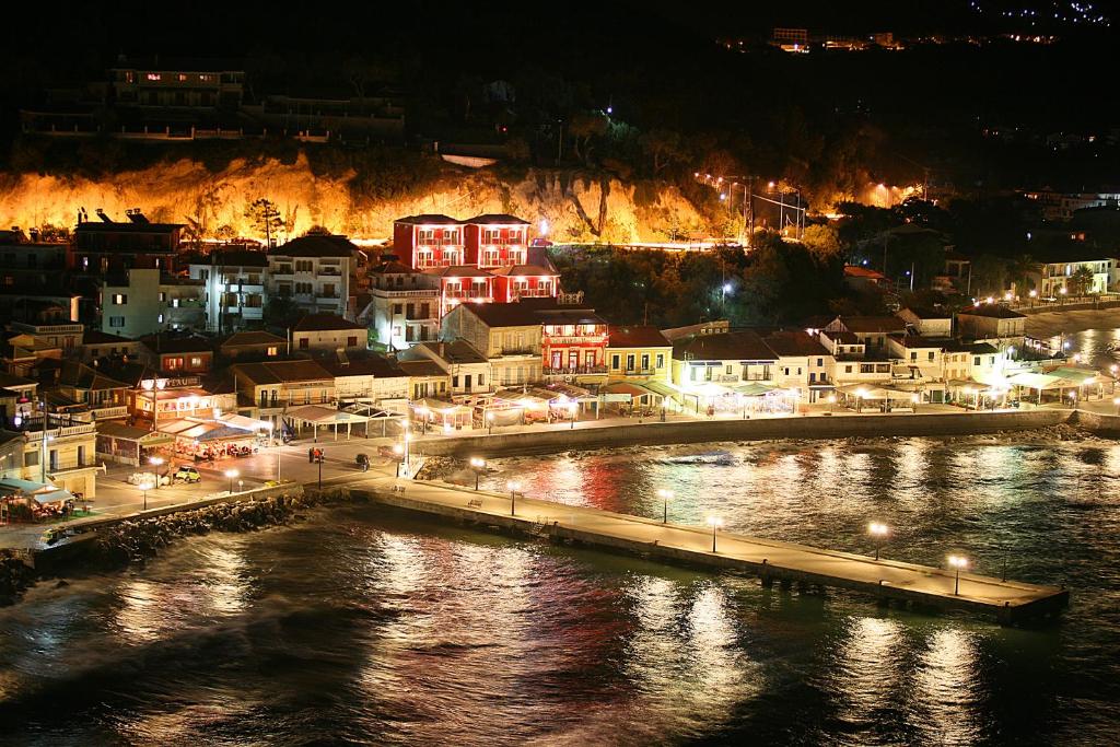 una ciudad por la noche con un río y edificios en Acrothea Hotel, en Parga