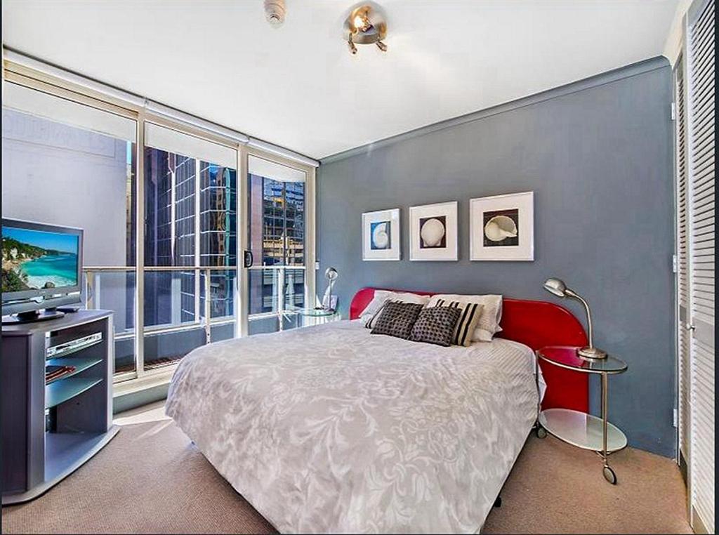 a bedroom with a large bed and a large window at Ausmine Sydney CBD 2Bedroom Apt in Sydney
