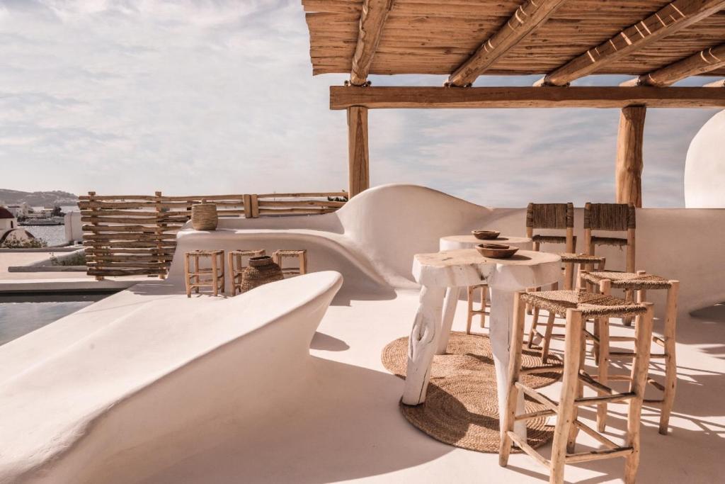 
a large white boat sitting on top of a sandy beach at MyCocoon Hostel in Mikonos
