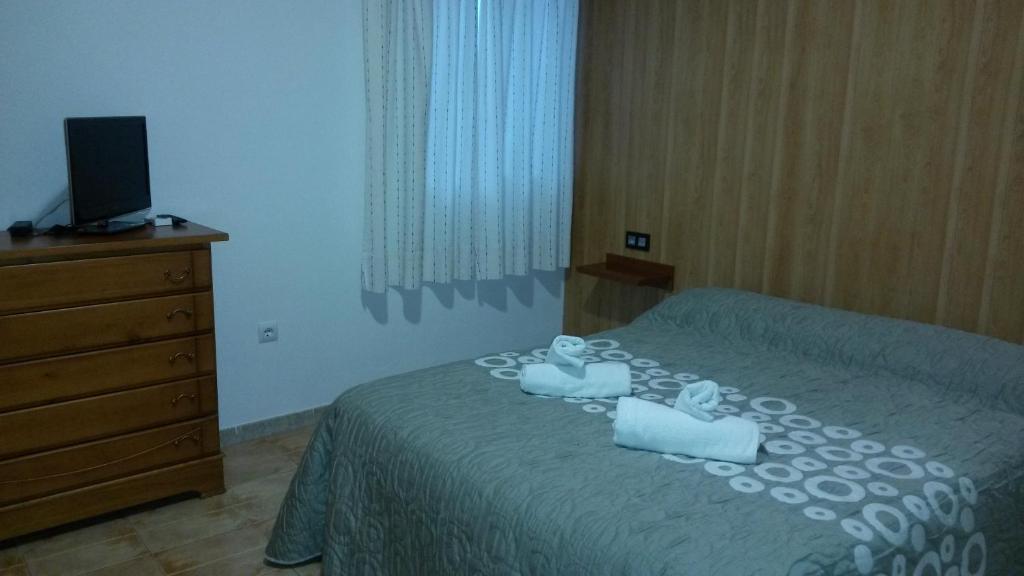 Posteľ alebo postele v izbe v ubytovaní Hostal Virgen Del Pilar