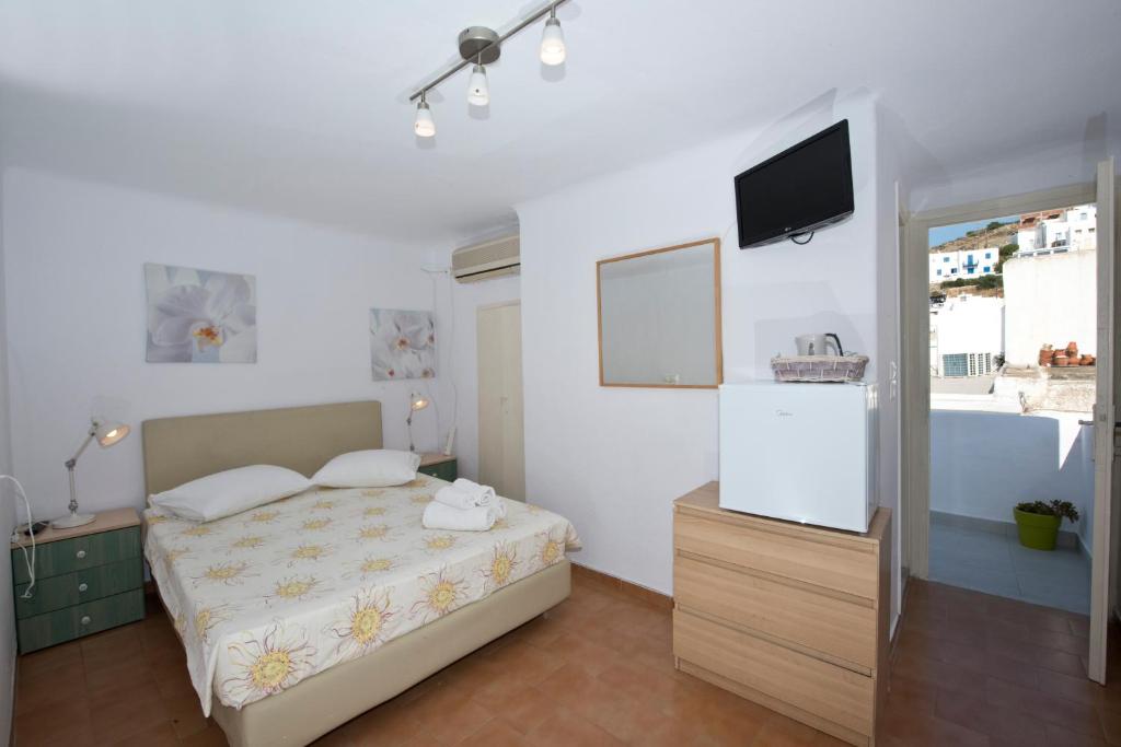 Postel nebo postele na pokoji v ubytování Karboni Hotel