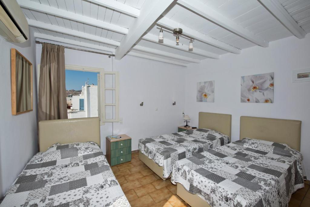 Postel nebo postele na pokoji v ubytování Karboni Hotel