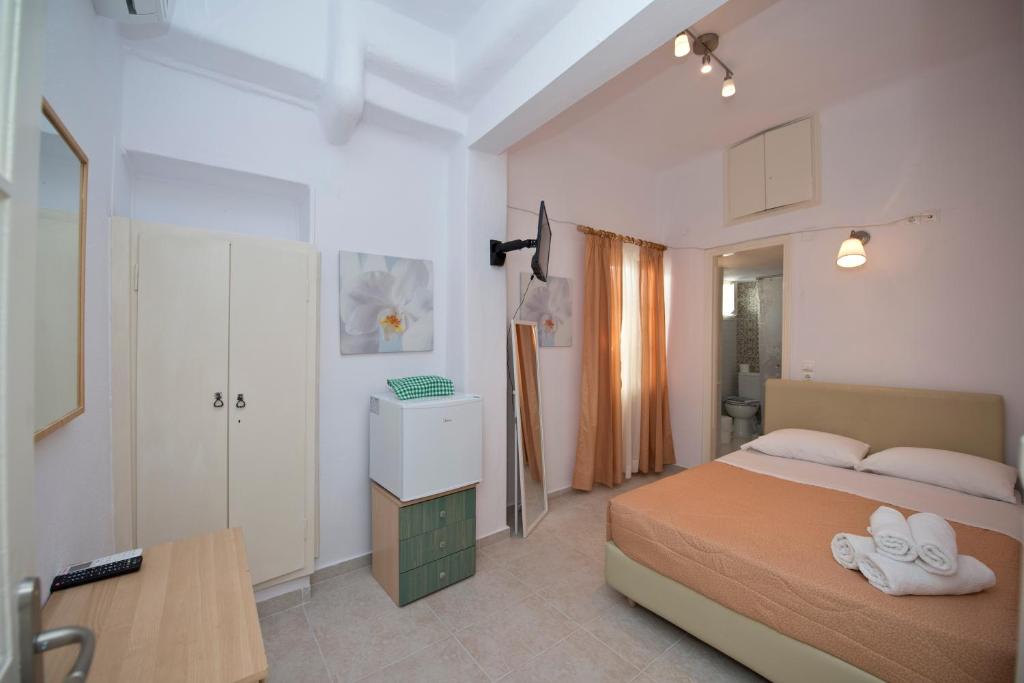 Postel nebo postele na pokoji v ubytování Karboni Hotel