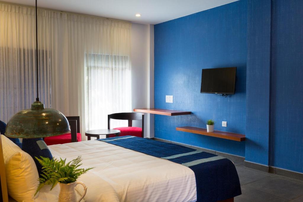 Postel nebo postele na pokoji v ubytování Hotel Neighbourhood, Cochin