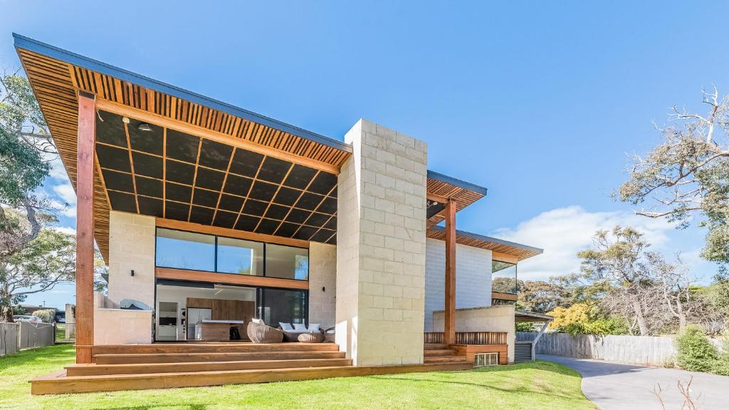 a house with a large window on the side of it at COASTAL ELEMENTS - FREE WIFI in Inverloch