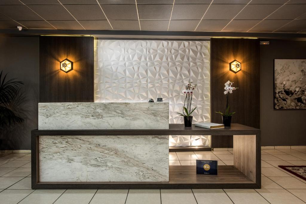 a reception desk in a lobby with marble at Galaxy Hotel in Ierapetra