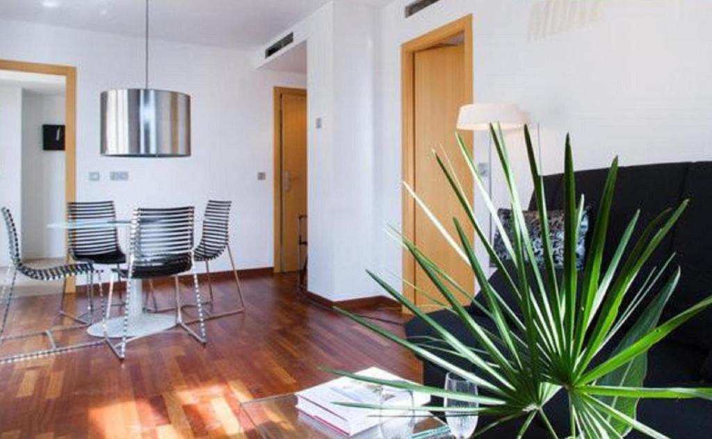 a living room with a table and a potted plant at Happy Apartments Valencia in Valencia