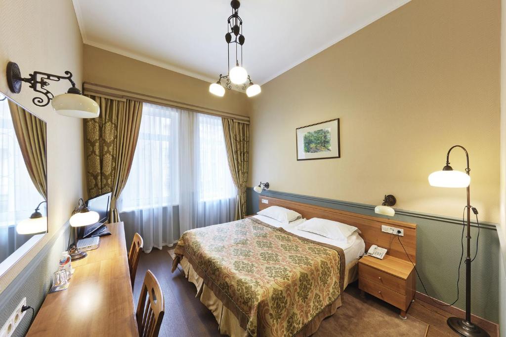Postel nebo postele na pokoji v ubytování Frapolli Hotel on Deribasivska street