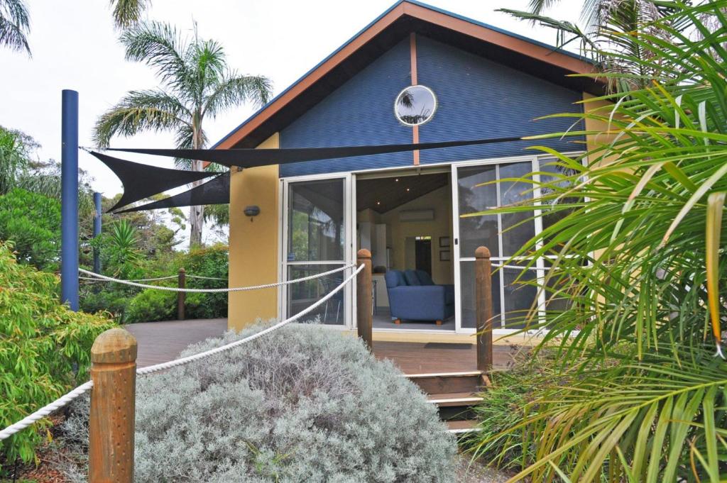 a blue house with a large glass door at THE SAILS 4 - CENTRAL LOCATION in Inverloch