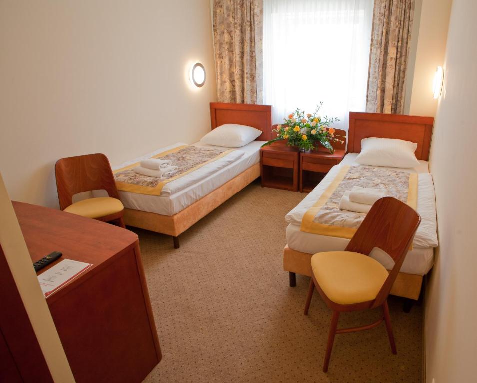 Postel nebo postele na pokoji v ubytování Hotel Rubin