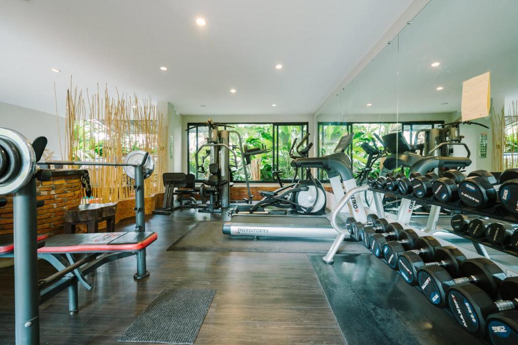 A second view of the gym showing cardio equipment and a long dumbbell rack.