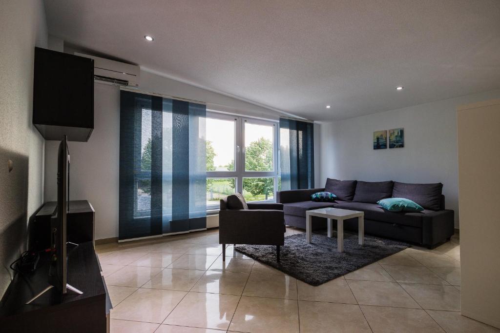 una sala de estar con un sofá y una mesa en Hoger Ferienwohung, en Lahr