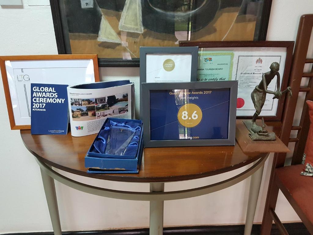 a table with a laptop computer on top of it at Roc Heights in Bakau