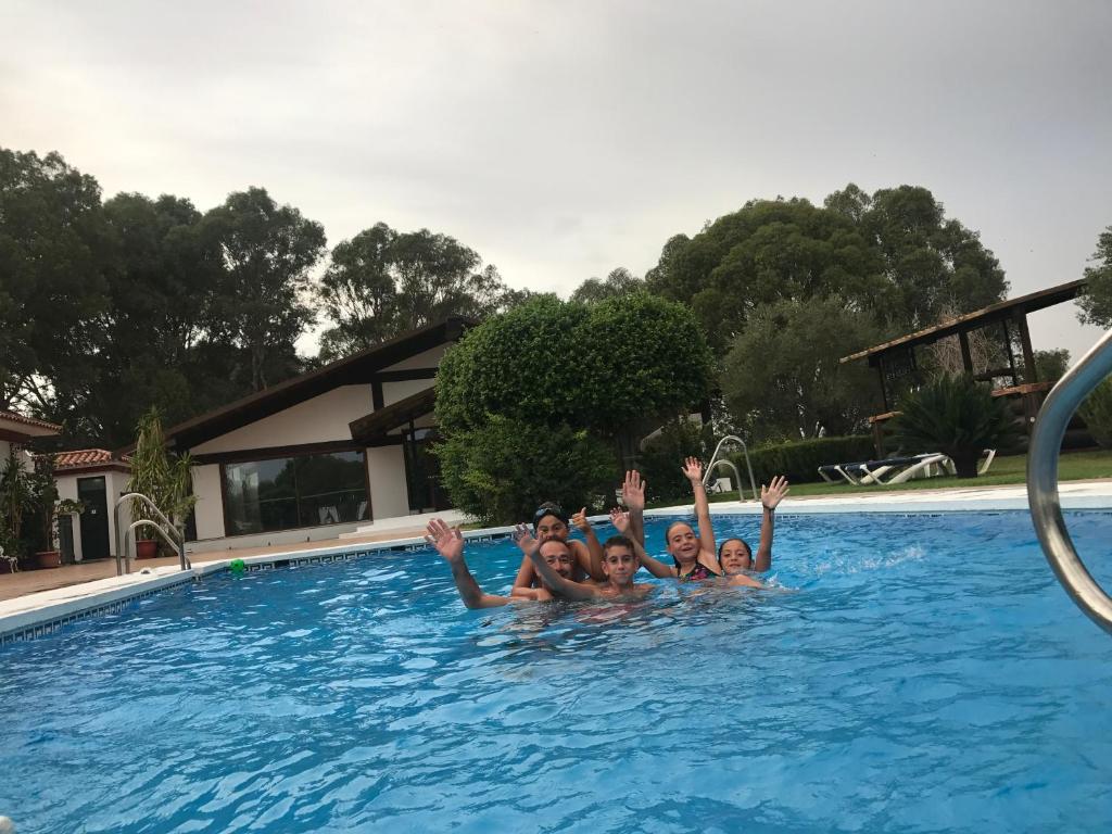 a group of people are in a swimming pool at Hotel El Paso in Vejer de la Frontera