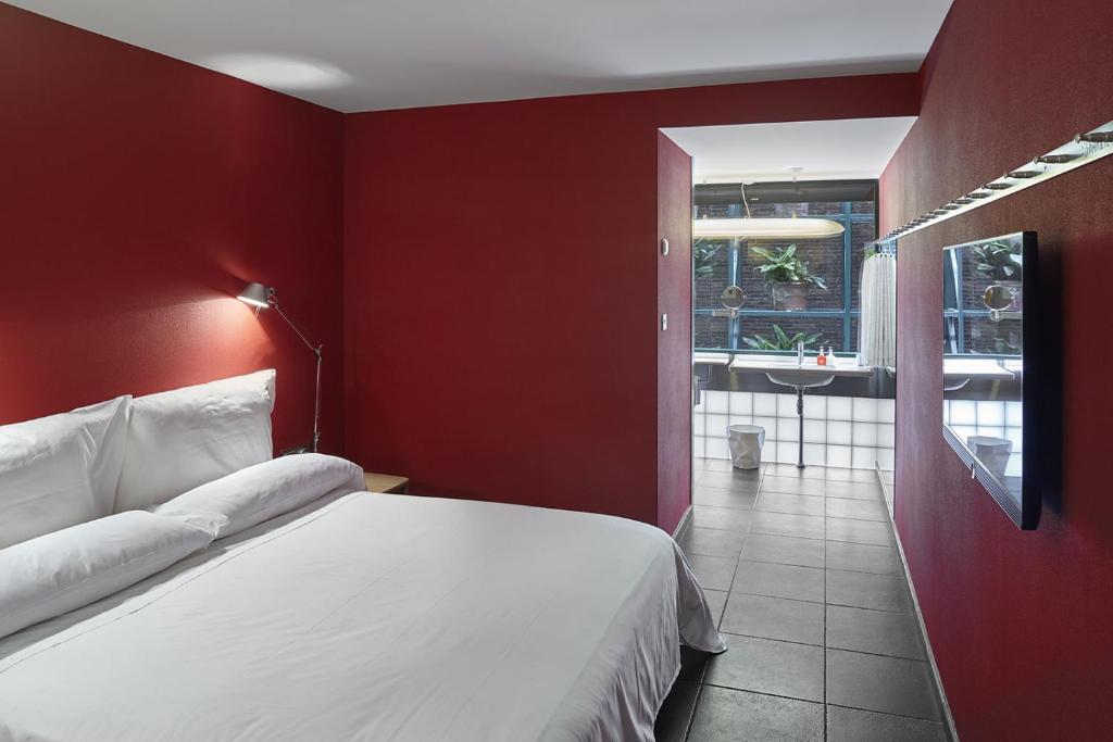a hotel room with a bed and a window at Casa Camper Barcelona in Barcelona