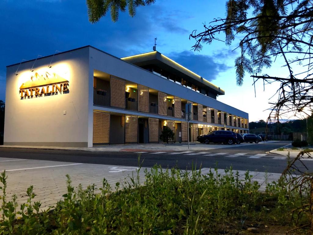 a building with a sign on the side of it at Tatraline Jasna in Liptovský Mikuláš