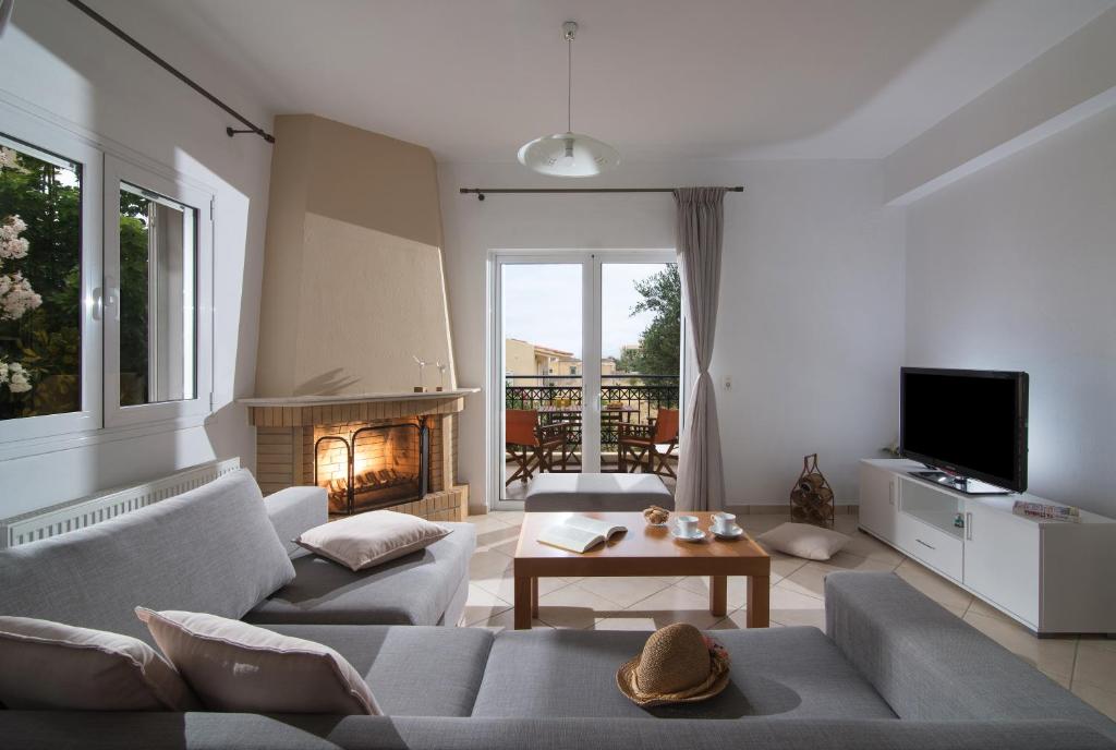a living room with a couch and a fireplace at Casa Di Giovani in Kokkini Khanion