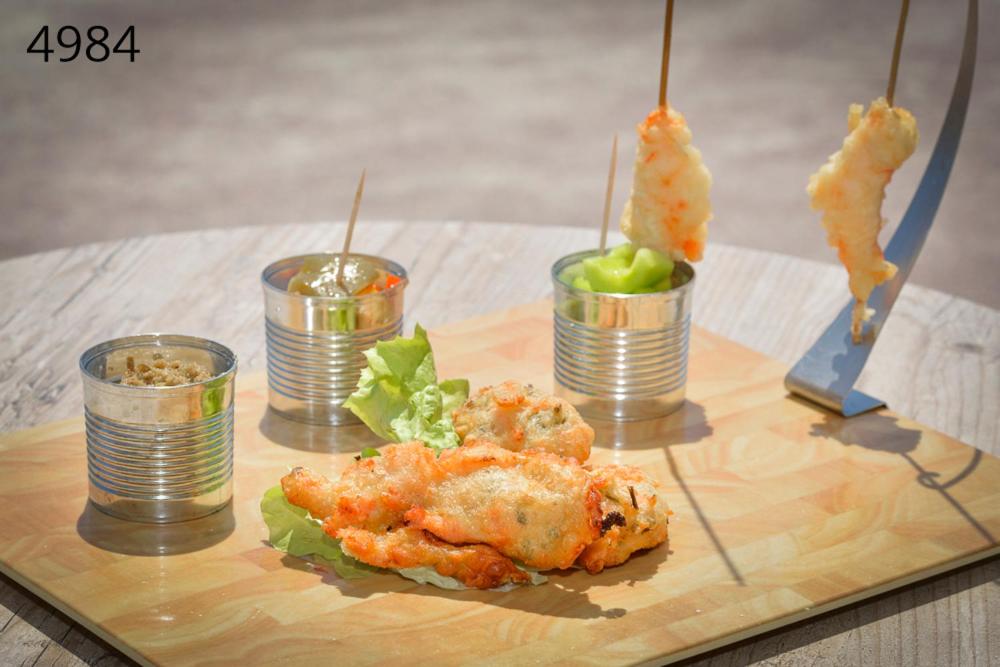 a table with some food in tin cans on a table at Hôtel George Sand in La Seyne-sur-Mer