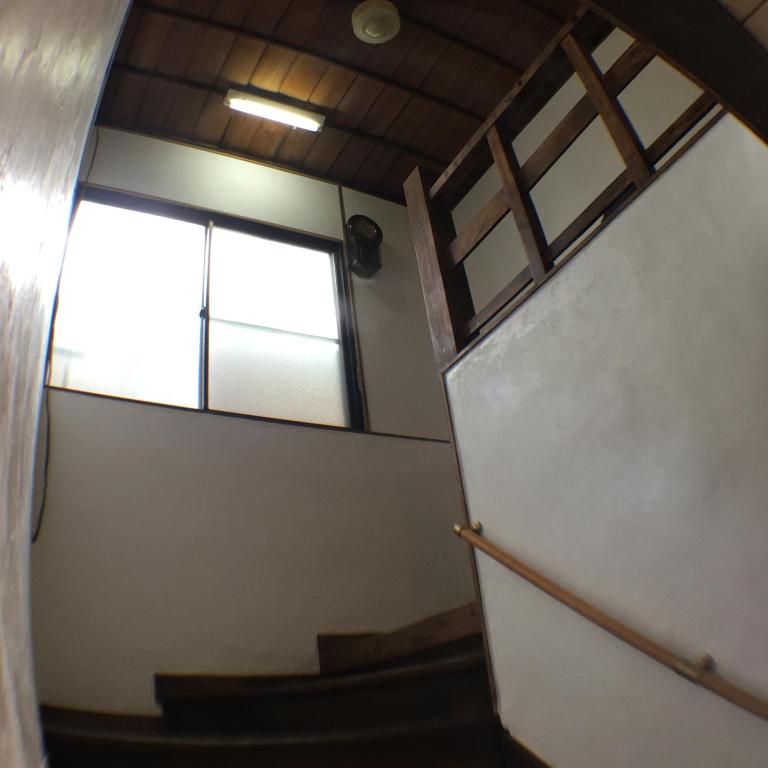 a view of a stairway with a window at Ryokan Nakadaya in Tokyo