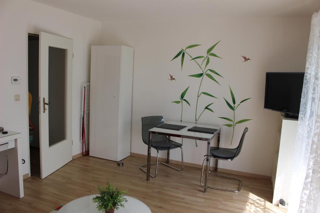 a living room with a table and a plant on the wall at ZV-Scholtz Burghausen Mozartstr, 15 AP-KL in Burghausen