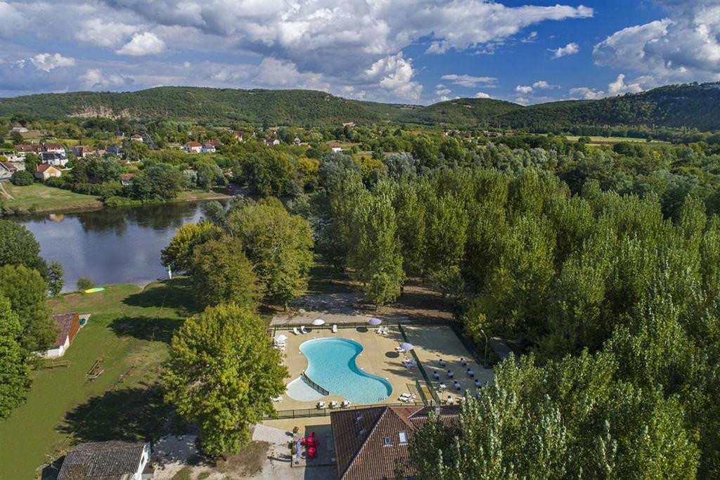 an aerial view of a park next to a river at Camping les Borgnes Saint-Sozy in Saint-Sozy